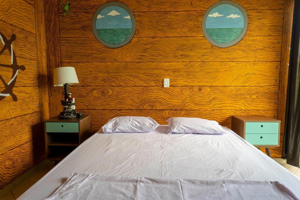 Quarto com paredes pintadas como se fossem o interior de um barco no Green Haven Hostel