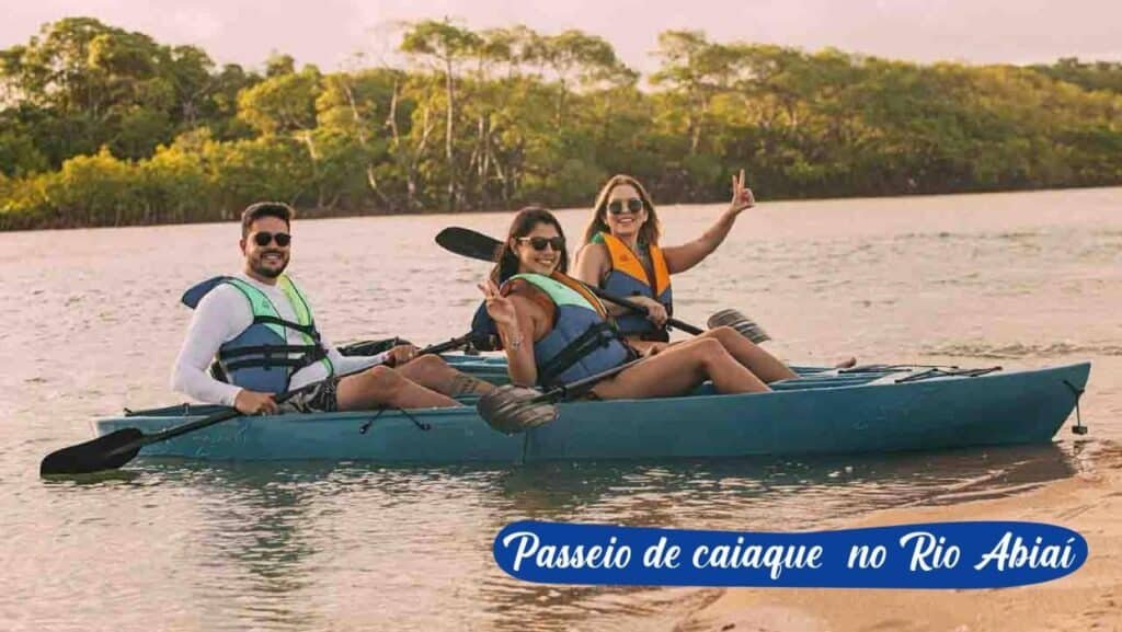 Três pessoas com coletes salva-vidas andando de caiaque em um rio com árvores ao fundo no Asenza Beach Resort All Inclusive. O texto diz "Passeio de caiaque no Rio Abiaí".