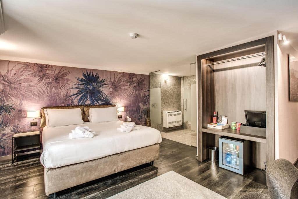 quarto do FOURHEADS Private Suites, um dos hotéis no centro de Roma, com cama de casal grande, tapete, vista do banheiro grande todo revestido, com uma ilha com comodidades para café