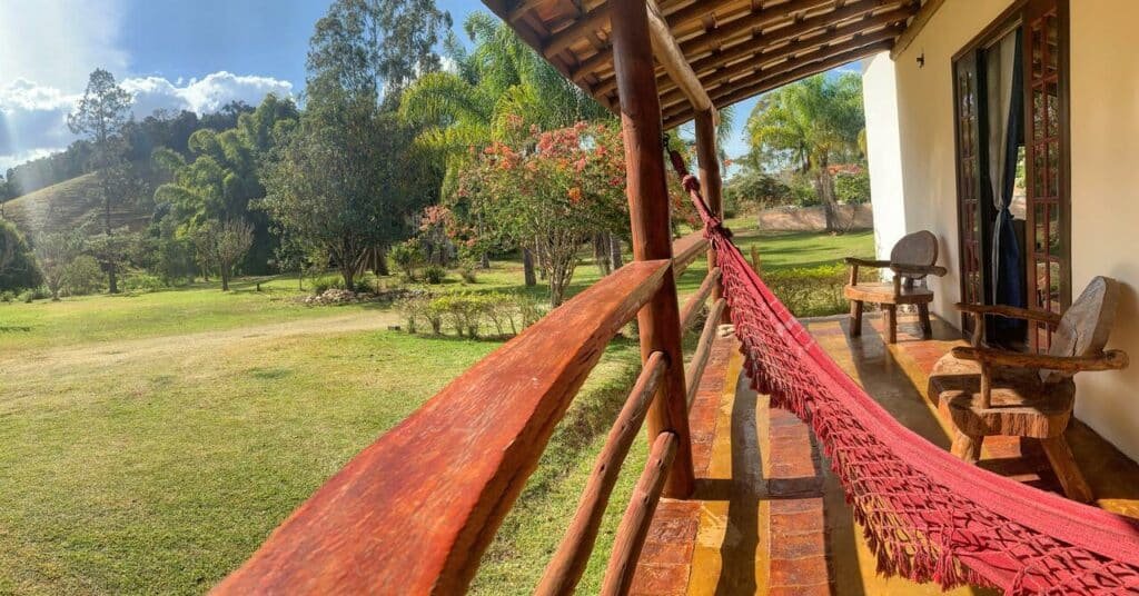 Varanda com rede e jardins do Recanto Roça Grande